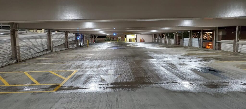 Commercial parking garage surface cleaning in Charlotte with the Lucid Bots LavoBot autonomous scrubbing robot shortens job times.