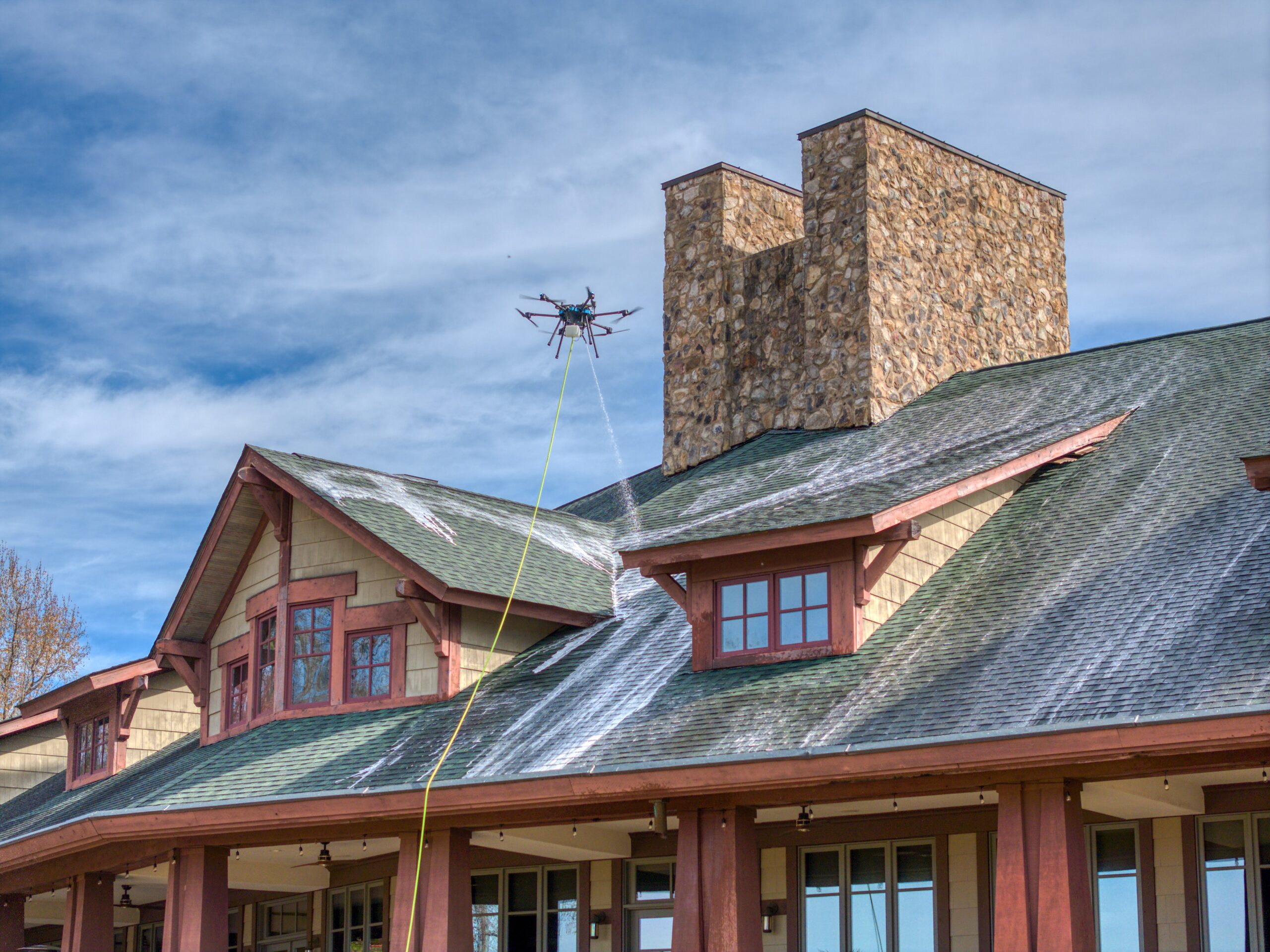 Drone roof cleaning and soft wash at Firethorne Country Club in Marvin, NC to remove lichen and preserve shingle longevity.